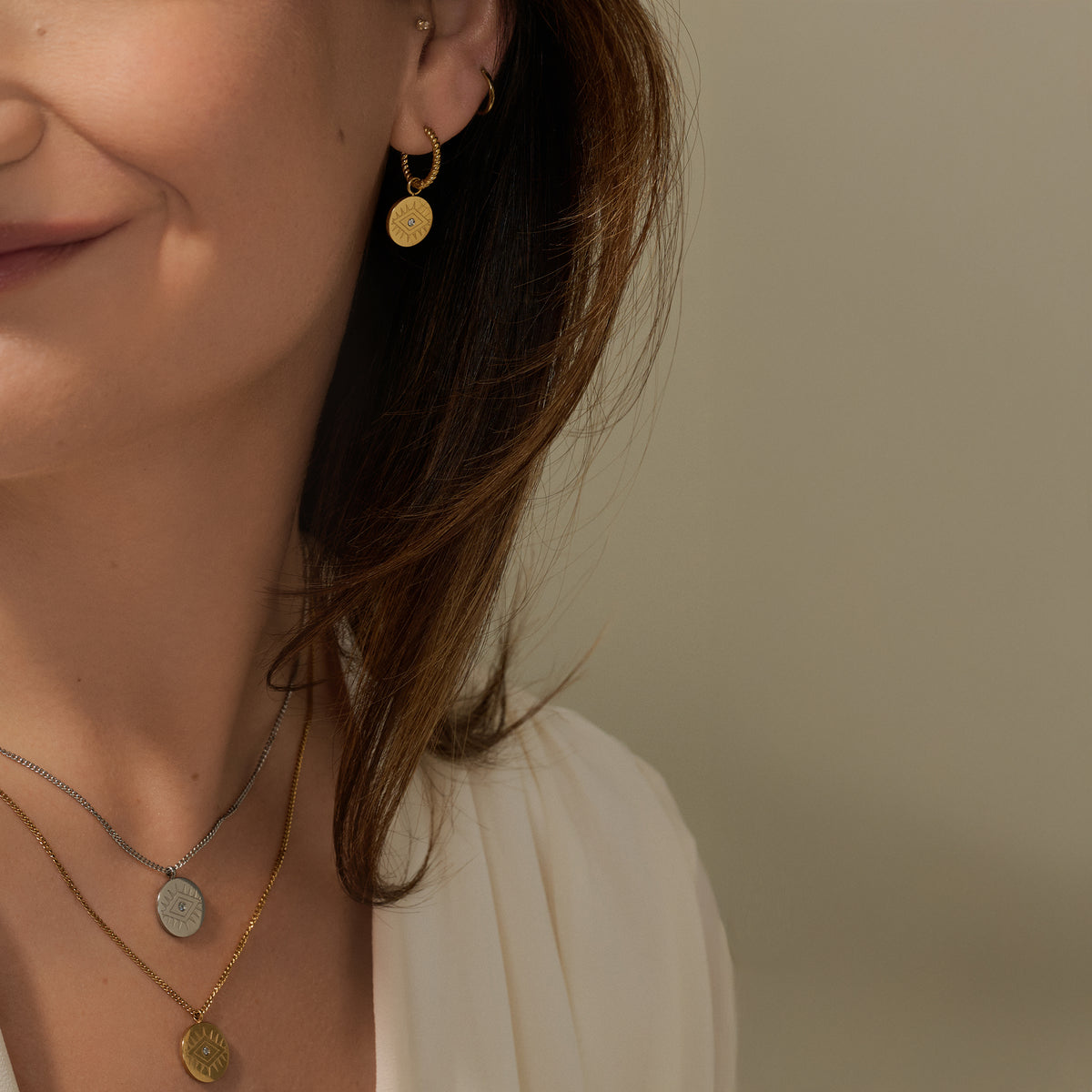 Layered evil eye gold and silver coin pendant necklaces with cubic zirconia, paired with evil eye huggie earrings – hypoallergenic, non-tarnish jewelry by Mia Bijoux Canada