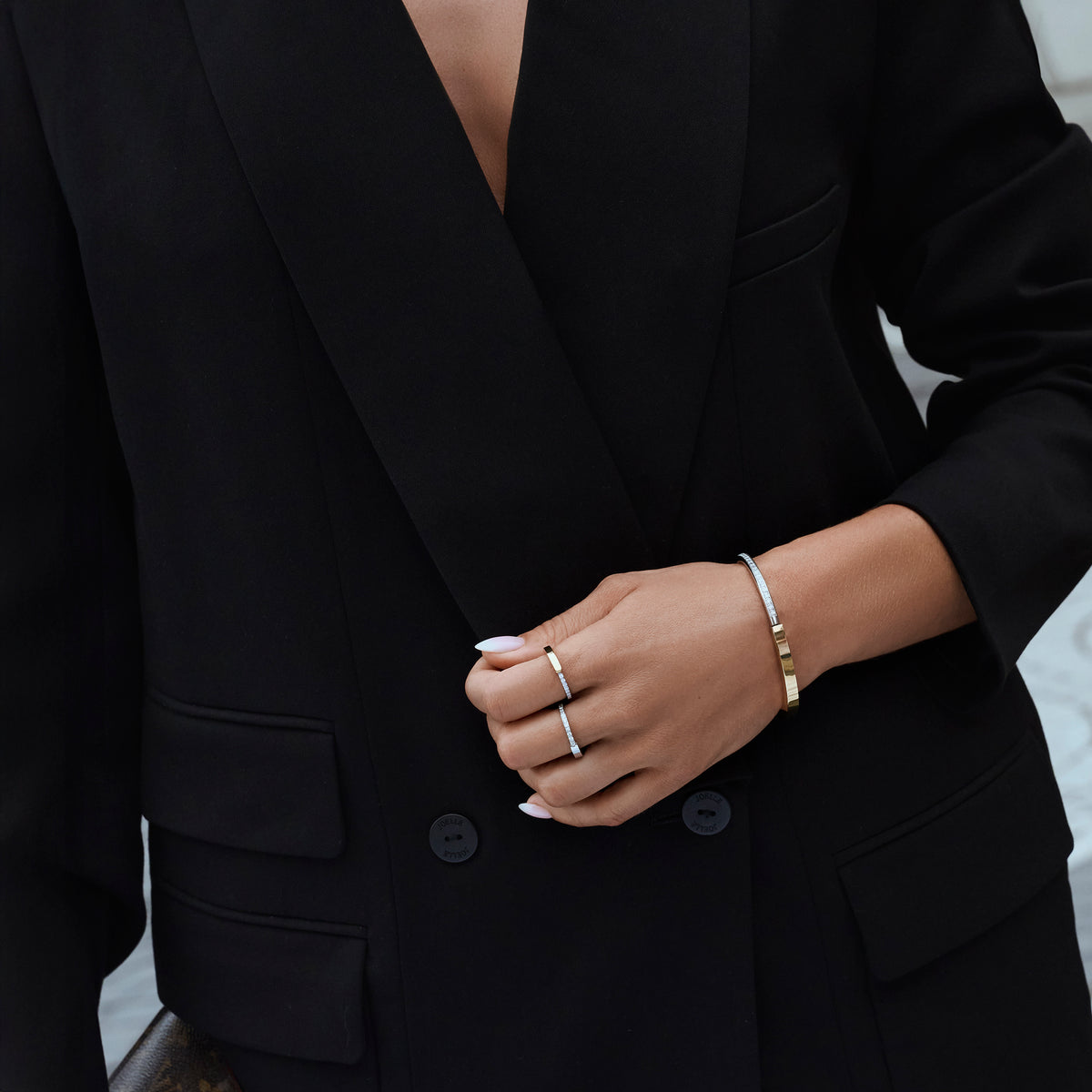 Silver stainless steel pavé cubic zirconia rings with two-tone gold and silver minimalist bangle bracelet, elegant modern jewelry styling, hypoallergenic non-tarnish durable everyday jewelry.
